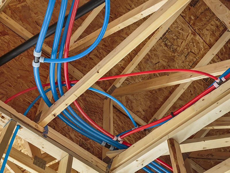 red and blue pipes on ceiling of new construction belle fourche sd